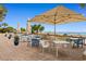 Charming outdoor dining area with tables, chairs, and umbrellas, perfect for enjoying meals by the ocean at 1105 Coral Beach Circle # 438, Myrtle Beach, SC 29577