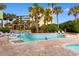 Resort-style pool with a lazy river and various water features surrounded by lush landscaping and lounge chairs at 1105 Coral Beach Circle # 438, Myrtle Beach, SC 29577