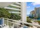 Balcony with a distant view of the ocean and palm trees at 1105 Coral Beach Circle # 438, Myrtle Beach, SC 29577