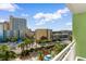 Balcony view showcasing palm trees, swimming pools, and multiple hotels in the distance at 1105 Coral Beach Circle # 438, Myrtle Beach, SC 29577