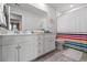 Well-lit bathroom with white cabinets, a large mirror, and a colorful shower curtain at 1210 Harbison Circle, Myrtle Beach, SC 29579
