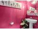Bright pink half bathroom with modern fixtures and decorative accents at 1210 Harbison Circle, Myrtle Beach, SC 29579