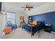Inviting bedroom with a blue accent wall, cozy bed, and decorative ceiling fan at 1210 Harbison Circle, Myrtle Beach, SC 29579