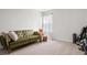 Bright bedroom featuring a comfy green couch, neutral walls, and soft carpet at 1210 Harbison Circle, Myrtle Beach, SC 29579