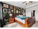 This bedroom features a black accent wall with art, a ceiling fan, and an ornate wood sleigh bed at 1210 Harbison Circle, Myrtle Beach, SC 29579