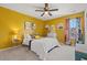 Stylish bedroom featuring vibrant yellow walls, a plush bed, and unique decor at 1210 Harbison Circle, Myrtle Beach, SC 29579