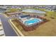 Aerial shot of a community pool, clubhouse, playground and pond in a large neighborhood at 1210 Harbison Circle, Myrtle Beach, SC 29579