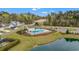 Aerial shot of a community pool, clubhouse, playground and adjacent pond at 1210 Harbison Circle, Myrtle Beach, SC 29579