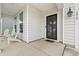 Inviting front porch with seating and a black-trimmed glass front door provides curb appeal at 1210 Harbison Circle, Myrtle Beach, SC 29579