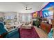 Spacious living room featuring a cozy fireplace, a plush sectional sofa, and vibrant decor at 1210 Harbison Circle, Myrtle Beach, SC 29579