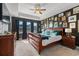Luxurious main bedroom featuring a tray ceiling, dark accent wall, and stylish furnishings at 1210 Harbison Circle, Myrtle Beach, SC 29579