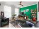 This office has an interesting wood desk, green accent wall and neutral walls, and hardwood flooring at 1210 Harbison Circle, Myrtle Beach, SC 29579