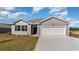 Charming single-story home featuring a two-car garage, gray siding, and a well-maintained front yard at 1451 Nokota Dr., Conway, SC 29526