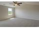 Bright bedroom featuring plush carpeting, a ceiling fan, neutral walls, and a window with natural light at 1490 Hardwick Rd., Conway, SC 29526