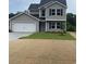 Charming two-story home featuring a gray exterior with a white garage door and a well-manicured lawn at 1490 Hardwick Rd., Conway, SC 29526