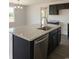 Kitchen with stainless steel appliances, dark cabinets, granite countertops, large sink, and tile flooring at 1490 Hardwick Rd., Conway, SC 29526