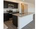 Modern kitchen with stainless steel appliances, granite countertops, dark cabinets, and a center island sink at 1490 Hardwick Rd., Conway, SC 29526