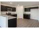 Modern kitchen with dark cabinets, stainless steel appliances, granite countertops, and wood-look flooring at 1502 Hardwick Rd., Conway, SC 29526