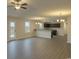 Open-concept living room with wood-look floors, modern lighting, and seamless flow into the kitchen area at 1502 Hardwick Rd., Conway, SC 29526