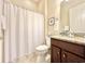 This bathroom features a granite countertop, a wood vanity, and a white shower curtain with starfish at 1652 Murrell Pl., Murrells Inlet, SC 29576