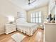 Well-lit bedroom featuring hardwood floors, crisp white bedding, and plantation shutters at 1652 Murrell Pl., Murrells Inlet, SC 29576