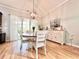 Bright dining room features hardwood floors, modern light fixture, and access to outdoor space through sliding glass doors at 1652 Murrell Pl., Murrells Inlet, SC 29576