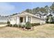 Well-maintained home featuring manicured landscaping, a charming front porch, and neutral exterior paint at 1652 Murrell Pl., Murrells Inlet, SC 29576