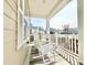 Inviting front porch with rocking chairs, a rug, and serene neighborhood views at 1652 Murrell Pl., Murrells Inlet, SC 29576