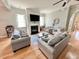 A living room features hardwood floors, two sofas, fireplace, and several large windows at 1652 Murrell Pl., Murrells Inlet, SC 29576