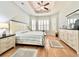 Spacious main bedroom boasts tray ceiling, ceiling fan, plantation shutters, and neutral color palette at 1652 Murrell Pl., Murrells Inlet, SC 29576