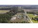 An aerial view shows single-Gathering homes in a community with surrounding fields and woods at 1892 Blue Bird Rd., Loris, SC 29569