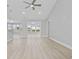 Open-concept living room with wood-look flooring and abundant natural light at 1892 Blue Bird Rd., Loris, SC 29569