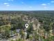 Aerial view of the home situated on a property surrounded by mature trees and shrubbery at 2 Sunrise Ct., Carolina Shores, NC 28467
