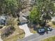 An aerial view of the home showcasing the mature trees and long driveway at 2 Sunrise Ct., Carolina Shores, NC 28467