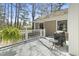 Outdoor back deck features white railings, a table, a grill, and a beautiful green fern at 2 Sunrise Ct., Carolina Shores, NC 28467