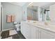 Bright bathroom featuring double vanity, framed mirror, and light blue walls at 2 Sunrise Ct., Carolina Shores, NC 28467