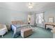 Bedroom with light blue walls features hardwood floors and ensuite bathroom at 2 Sunrise Ct., Carolina Shores, NC 28467