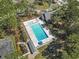 An aerial view of the community pool and lounging area with palm trees at 2 Sunrise Ct., Carolina Shores, NC 28467