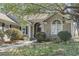 Charming single-story home with neutral siding, mature trees, and an arched front door at 2 Sunrise Ct., Carolina Shores, NC 28467