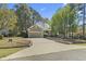 Charming home showcasing a well-manicured lawn, mature trees, and a two-car garage at 2 Sunrise Ct., Carolina Shores, NC 28467