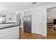 Bright kitchen features stainless steel refrigerator, white cabinets, and hardwood floors at 2 Sunrise Ct., Carolina Shores, NC 28467