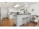 Eat-in kitchen area features white cabinets, bar seating, and hardwood floors at 2 Sunrise Ct., Carolina Shores, NC 28467