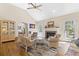 Spacious living room with hardwood floors, fireplace, and access to a sunroom and kitchen at 2 Sunrise Ct., Carolina Shores, NC 28467