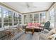 Bright sunroom with hardwood floors and comfortable seating area at 2 Sunrise Ct., Carolina Shores, NC 28467