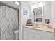 Bathroom with a peach countertop, white cabinetry, toilet and shower with curtain at 2001 S Ocean Blvd. # 720, Myrtle Beach, SC 29577