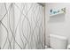 Bathroom toilet and shower combination with a white and grey patterned shower curtain at 2001 S Ocean Blvd. # 720, Myrtle Beach, SC 29577