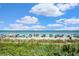 Stunning beach with ocean views filled with umbrellas, beachgoers, and lush greenery at 2001 S Ocean Blvd. # 720, Myrtle Beach, SC 29577