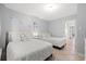 Bright bedroom featuring two beds with white bedding, tile flooring, and beach themed decorations at 2001 S Ocean Blvd. # 720, Myrtle Beach, SC 29577