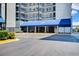 Welcoming resort entrance with a covered awning, lush landscaping, and convenient parking at 2001 S Ocean Blvd. # 720, Myrtle Beach, SC 29577