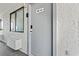 Condo entrance featuring a grey door, a window, and light-colored stucco walls at 2001 S Ocean Blvd. # 720, Myrtle Beach, SC 29577